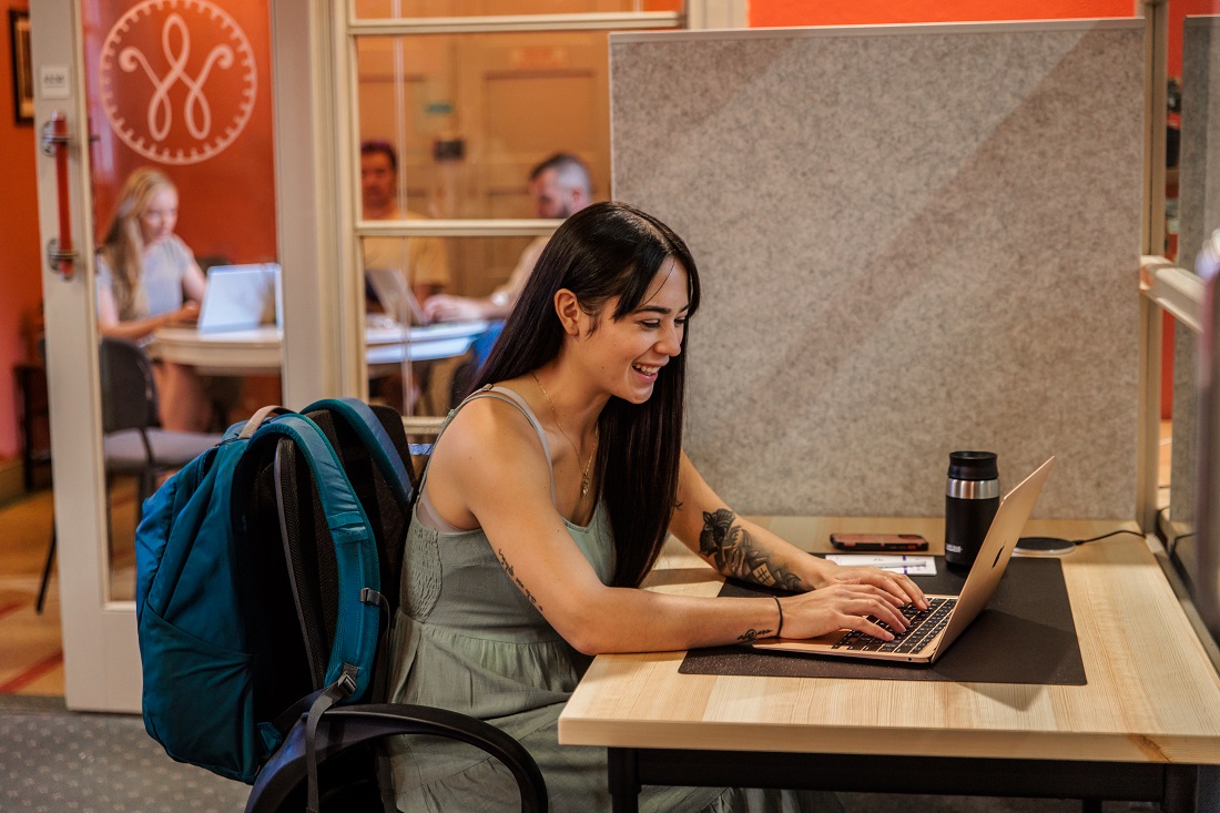 Person on Laptop in Meeting Room Hive.jpg